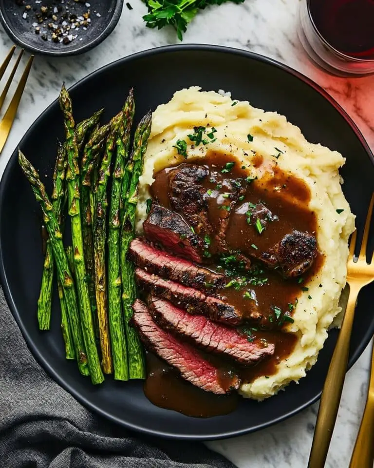 Bavette Steak with Roasted Garlic Pan Sauce, Fingerling Potatoes, Asparagus, and Chive Sour Cream Recipe