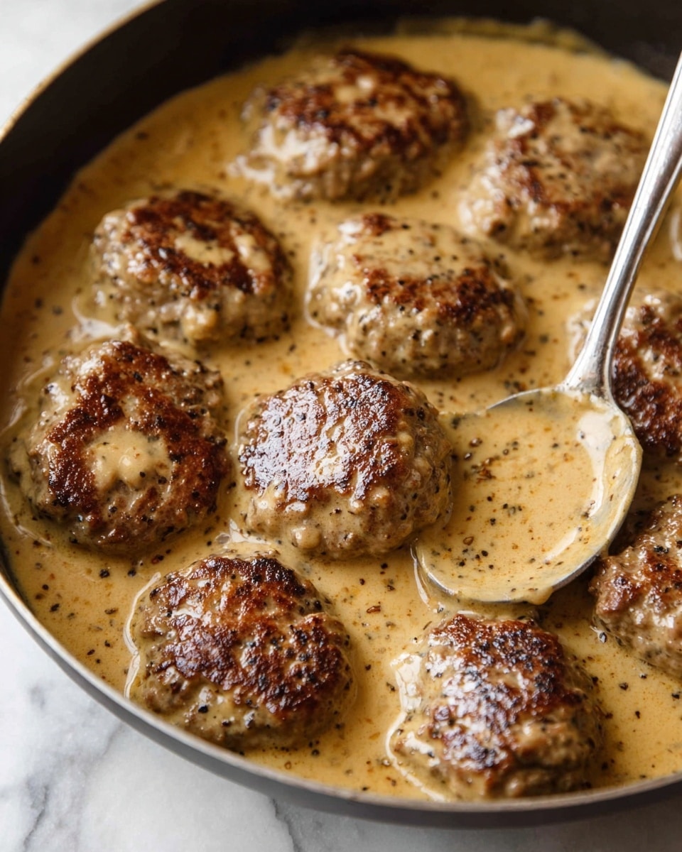 A white plate shows a meal with two main parts: on the left are several golden brown potato wedges, crispy on the edges and sprinkled with herbs; on the right are three brown meat patties covered with a light beige sauce and herbs on top. One patty is pierced by a fork and a small piece of it is held by the fork, showing a tender, cooked inside with a soft texture. A bright yellow lemon wedge rests on the top right edge of the patties. The plate sits on a white marbled surface. Photo taken with an iphone --ar 4:5 --v 7