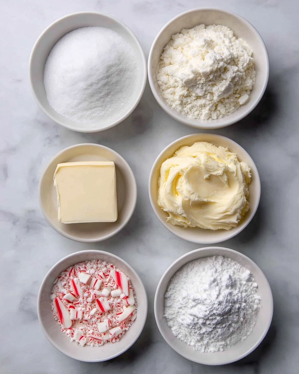 There are five small white bowls on a white marbled surface, each holding different baking ingredients. The top left bowl contains white granulated sugar with a smooth texture. To its right, another bowl is filled with a light, powdery white flour, piled high with a slightly rough surface. Below the sugar, there is a bowl with a thick, creamy off-white butter, showing soft, uneven peaks. Next to the butter, a bowl holds a small, neat square of pale yellow butter or margarine with smooth edges. Finally, the bottom left bowl is filled with crushed red and white striped peppermint candies, showing irregular shard shapes and rough texture. photo taken with an iphone --ar 4:5 --v 7