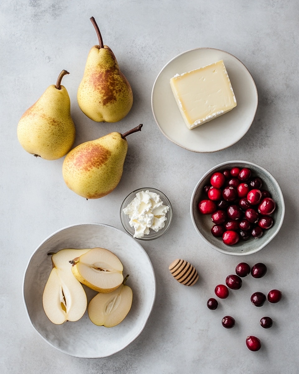The image shows two pear halves placed on a white plate with a white marbled surface beneath. Each pear half is golden yellow with a smooth, shiny skin and tiny brown speckles. On top of each pear half, there is a thick white cheese layer that looks soft and creamy. This cheese is sprinkled with small dark red dried fruit pieces and crumbs, adding a rough texture and deep color contrast. A glossy dark red berry and a small green sprig of rosemary sit on each cheese layer for garnish. The pear halves are surrounded by a light amber syrup pooling slightly on the plate, giving a wet and shiny finish. In the background, more red berries are scattered softly out of focus. The photo taken with an iphone --ar 4:5 --v 7