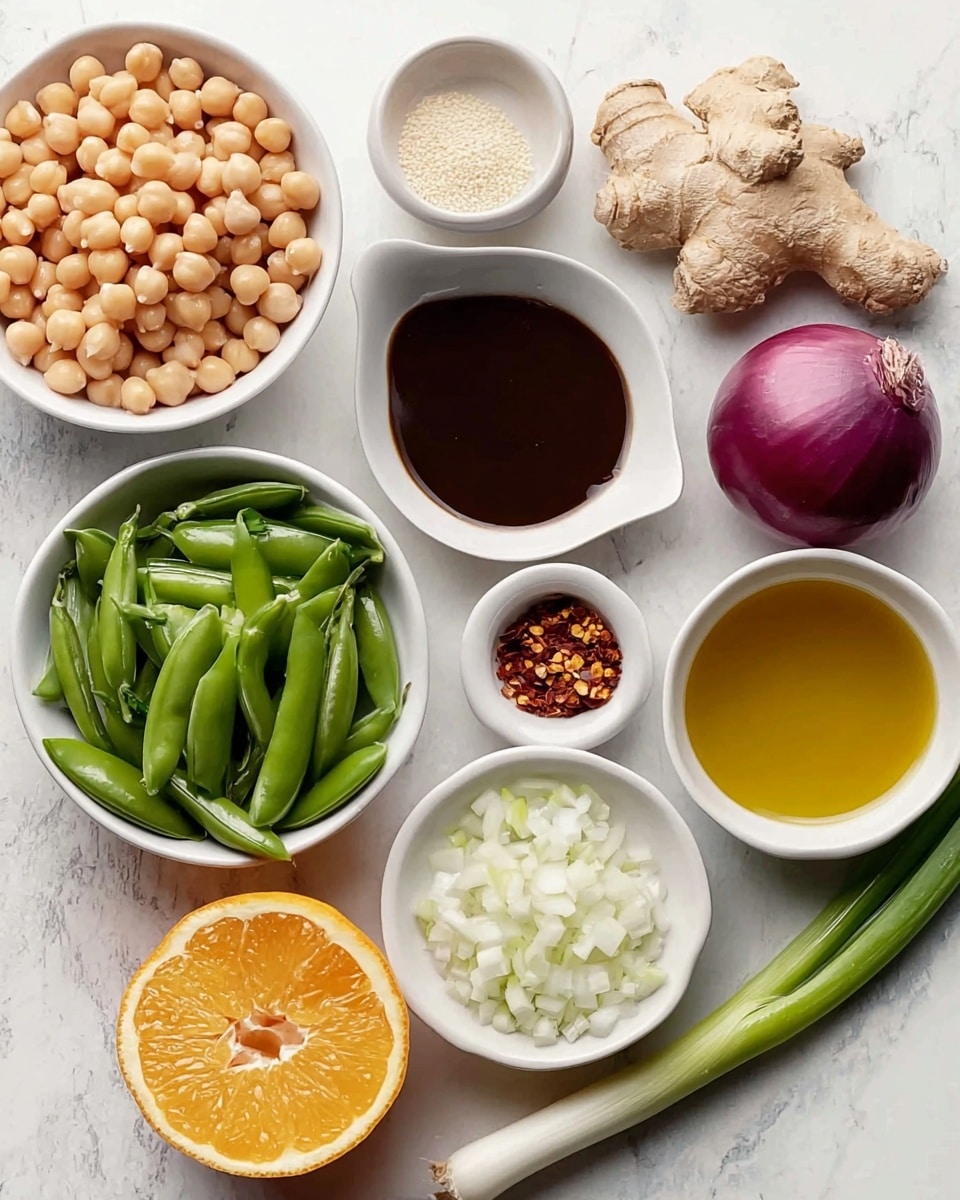 The image shows several small white bowls and a white oval dish arranged on a white marbled surface. There are light beige chickpeas in one bowl, finely chopped white onions in another, and bright green whole snap peas in a third oval bowl. A small bowl holds red chili flakes, and another contains off-white sesame seeds. The oval dish holds a thick dark brown sauce, and a round bowl has a golden yellow liquid. Nearby, there is a halved orange showing its bright orange inside, a half purple-red onion with white interior rings, a piece of knobby light brown ginger, and two green onions with white bottoms and light green tops. photo taken with an iphone --ar 4:5 --v 7