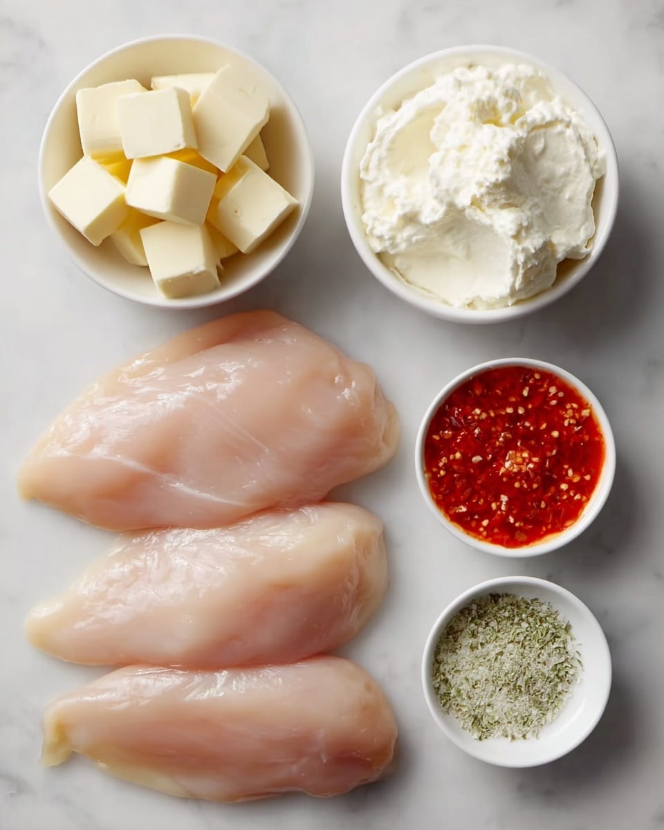 The image shows four raw chicken fillets placed horizontally in the lower left part of the image, their smooth, pale pink surface slightly shiny and moist. In the top left, there is a round white bowl filled with evenly cut pale yellow cubes of butter. Next to it on the right is another round white bowl filled with a thick, creamy white mixture. Below that, on the right side, two smaller white bowls are placed vertically: the top one contains a bright red chili sauce with visible bits of chili, and the bottom one holds a light greenish-white powdery herb seasoning. All the items rest on a white marbled surface. Photo taken with an iphone --ar 4:5 --v 7