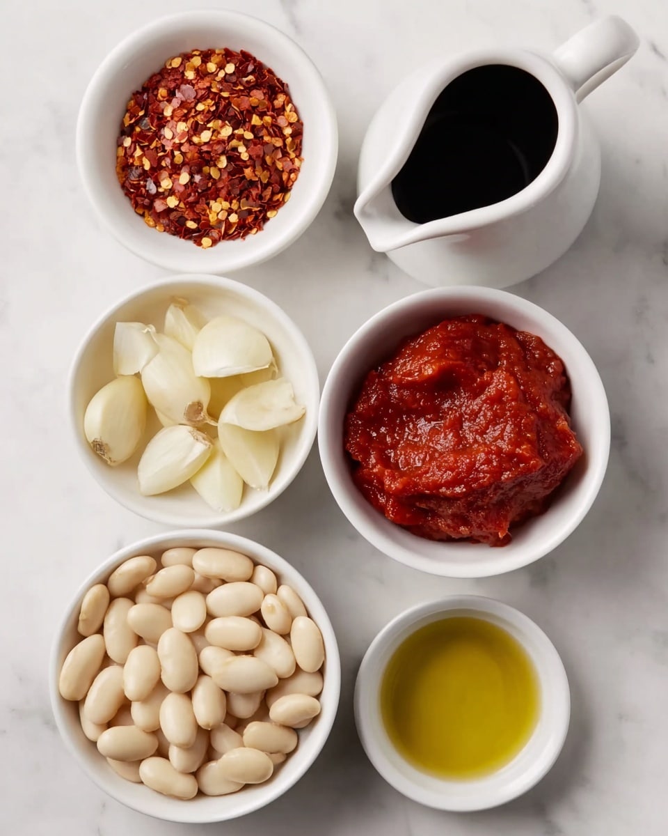 The image shows six small white bowls arranged on a white marbled surface, each containing a different ingredient. Starting from the top left, there are two garlic cloves with a pale cream color and smooth texture. Next to it, a bowl holds bright red chili flakes with a rough, grainy texture. To the right, a white jug contains dark brown soy sauce with a glossy surface. Below, one bowl is filled with thin, pale white garlic slices with a slightly translucent appearance. Another bowl holds a thick, red tomato paste with a chunky texture. Finally, at the bottom left, a bowl is filled with whole white beans that have a smooth, shiny surface, and next to it, a small bowl contains light golden olive oil with a clear and glossy liquid surface. Photo taken with an iphone --ar 4:5 --v 7