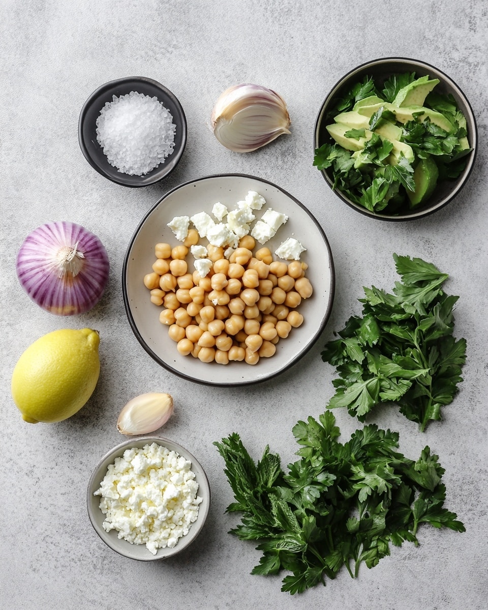 A mixed salad in a white bowl with a white marbled texture surface underneath shows layers of chunky light green avocado pieces, round beige chickpeas, and small cubes of white cheese scattered throughout. Bright purple rings of sliced onion are spread evenly across the top, with chopped green herbs sprinkled on everything. A dark speckled seasoning and oil dressing lightly coats the ingredients, adding shine and texture to the colorful mix. photo taken with an iphone --ar 4:5 --v 7