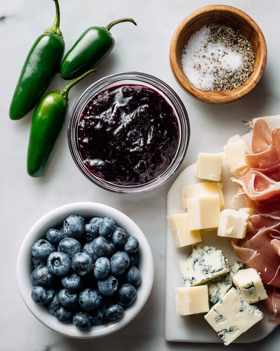 A white marbled surface holds a small clear glass bowl filled with dark purple jam with a shiny, thick texture as the center. To the left are three whole bright green jalapeños with smooth skins aligned vertically. Below the jalapeños, a small white wooden bowl contains plump, fresh blueberries with a soft blue hue. Above the jam, a small white wooden bowl holds coarse salt mixed with cracked black pepper. To the right, a white plate is layered with uneven cubes of pale yellow and blue-veined cheese, alongside thin, translucent folds of light pink prosciutto with white fat streaks. Photo taken with an iphone --ar 4:5 --v 7