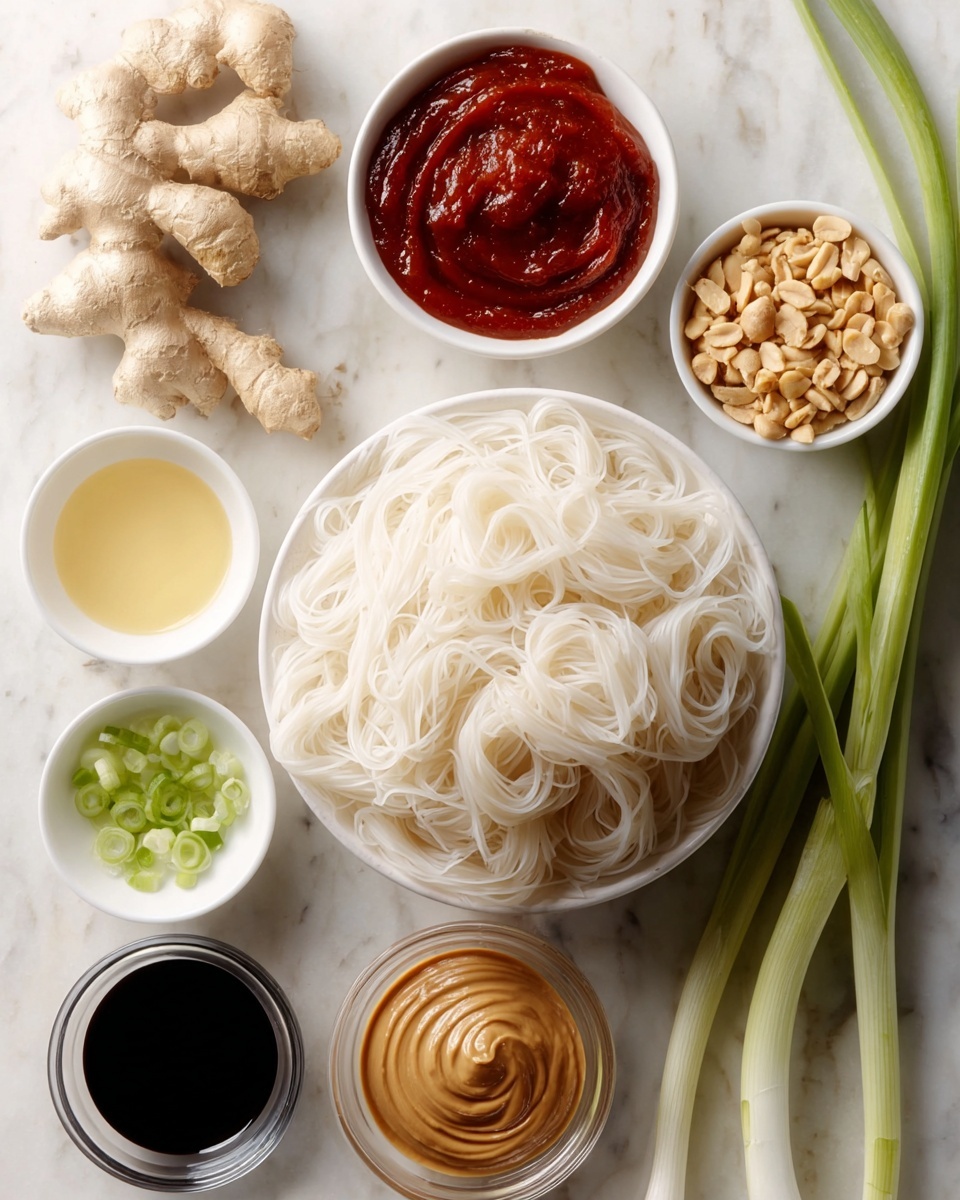 A close-up view of a black pan filled with shiny, light brown noodles twisted and layered throughout the pan. The noodles are topped with small, chopped green onions and white chopped nuts scattered unevenly on top. A wooden spoon is lifting a portion of the noodles from the pan, showing their slippery and smooth texture. The background shows a white marbled texture. photo taken with an iphone --ar 4:5 --v 7